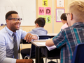 Teacher smiling at student