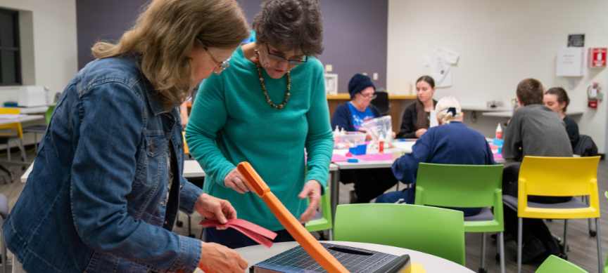 Adults using paper cutter